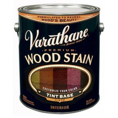 a can of wood stain that is black and has various colors on it, including red