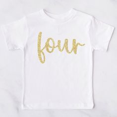 White t-shirt, girls 4th birthday t-shirt - features a 'four' print in gold glitter. Our t-shirts are 100% cotton. We print using an extremely high quality vinyl - it can be washed at 40 degrees & tumble dried on a low setting. + 𝕄𝕒𝕜𝕖 𝕥𝕚𝕞𝕖 & 𝔻𝕖𝕝𝕚𝕧𝕖𝕣𝕪 + We post using Royal Mail & you can choose from a range of different delivery options at checkout.  Our make time is usually around 3-5 business days, so please make sure that you take note of this and check the delivery estimates w Gold T-shirt With Letter Print For Summer, Gold Short Sleeve T-shirt With Text Print, Gold Crew Neck T-shirt With Text Print, Gold Letter Print Top For Summer, Gold Letter Print Tops For Summer, Gold Top With Graphic Print For Birthday, Gold Graphic Print Top For Birthday, Gold Graphic Tee With Letter Print, Gold Top With Graphic Print