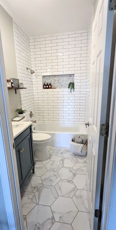 a bathroom with a toilet, sink and bathtub