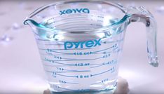 a measuring cup filled with water on top of a table