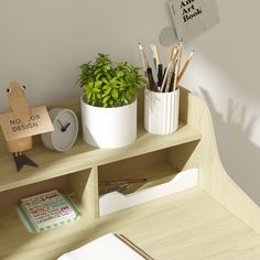 there is a potted plant on the shelf next to some books and pencils