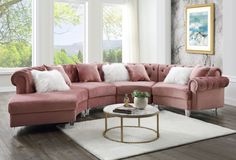 a living room with pink couches and white rugs