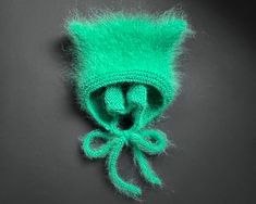 Mohair hat for adults with cute cat ears. This product is made especially for you as soon as you place an order. Please allow up to 3-7 business days production time before shipping. Colour name: GREEN. Made to order in 24 colors. Size: Stretch to fit ( 22-23 in / 56-58 cm) Composition: 50% mohair, 50% acrylic Recommended Care Instructions: Hand wash only. Dry flat. Made entirely by hand! Please note that real colors may slightly differ from their appearance on your display. Green Handmade Bonnet One Size Fits Most, Handmade Green Bonnet, One Size Fits Most, Handmade Green Bonnet One Size, Fitted Warm Green Hat, Handmade Adjustable Green Bonnet, Adjustable Knitted Green Bonnet, Adjustable Green Knitted Bonnet, Handmade Green Bonnet For Winter, Handmade Green Winter Bonnet