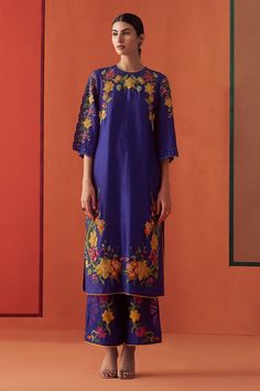 Cobalt blue chanderi kurta with multi-colored beads and floral applique embroidery. Comes with pant.
Components: 2
Pattern: Applique embroidered
Type Of Work: Beads, Floral
Neckline: Round
Sleeve Type: Flared Sleeves
Fabric: Chanderi, Lining : 100% Cotton
Color: Blue
Other Details: 
Attached lining
Model Height : 5 ft 6 inches, wearing size S
Occasion: Sangeet - Aza Fashions Embroidered Beads, Embroidered Kimono, Semi Casual, Embroidered Pants, Organza Dupatta, Kurta With Pants, Floral Applique, Pant Set, Blue Beads