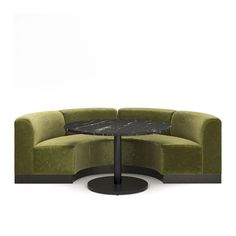 a green couch with a black table in front of it