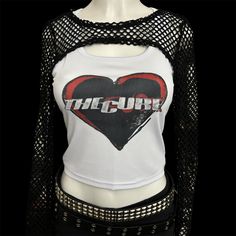 * Sublimated 1980s gothic post punk new wave band heart cropped tank top * Mannequin is wearing size L * Mannequin measurements:    * Bust: 35" (C cup)    * Waist: 26"    * Hip: 40" * Soft, breathable, and stretchy material * For a looser fit, size up * Please note that all items are Made to Order & there may be slight variations in appearance Stretch Punk Crop Top For Streetwear, Punk Style Tank Top For Club And Spring, Punk Style Tank Top For Spring Club Events, Punk Style Tank Top For Club In Spring, Punk Style Stretch Cropped Tops, Punk Style Tank Top For Spring Club Season, Punk Style Cropped Stretch Tops, Stretch Cropped Punk Tops, Y2k Tank Crop Top For Club