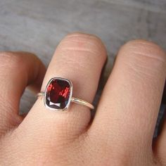 Red Garnet January Birthstone Ring for Her, Garnet Cushion Ring, Garnet Solitaire Ring, Christmas Gift for Her Garnet Ring, Red Garnet January birthstone, Birthstone Jewelry, Cushion Shape, Solitaire This deep red garnet ring features this rectangular cushion cut gemstone set in a sterling silver ring. The color of this gemstone is deep and bright red at once, full of bright red fire, sometimes a flash of peachy orange shows up in the sunlight. A gorgeous red cocktail ring that will get you comp Red Cushion Cut Ring With Accent Stones, Modern Rings With Gemstone Accents As Gifts, Red Cushion Cut Gemstone Jewelry, Emerald Cut Garnet Rings As Gift, Emerald Cut Garnet Rings For Gift, Modern Red Ruby Wedding Ring, Modern Red Ruby Ring For Wedding, Rectangular Birthstone Ring As Gift, Ruby Birthstone Ring With Gemstone Accents As Gift