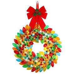 a christmas wreath with red bow hanging from the side on a white background, decorated with multicolored glass beads