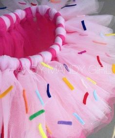 a pink tutu with colorful sprinkles on it