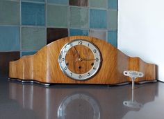 a wooden clock sitting on top of a counter