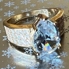 an image of two wedding rings on top of snowflakes with one ring in the middle