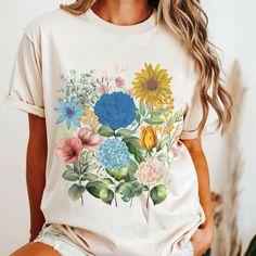 Looking for a unique boho floral tee or a special birthday gift t shirt? Look no further! Our trendy boho wildflowers shirt is designed to delight and make you stand out in style. 🎁👕 See more items here: https://www.etsy.com/shop/ShineMoonDesigns?section_id=47203323 See the kids shirts here: https://www.etsy.com/shop/ShineMoonDesigns?section_id=45407634 See the rest of our store here: https://www.etsy.com/shop/shinemoondesigns COMFORT COLORS 1717 UNISEX SHIRT INFO 👚 Premium Fabric Comfort: ► Printed Summer Tops As A Gift, Multicolor Bohemian T-shirt For Spring, Multicolor Short Sleeve Tops For Garden Party, Bohemian Spring Shirt With Plants Print, Cottagecore Floral Print Top For Garden Party, Bohemian Shirt With Plants Print For Spring, Multicolor Summer Shirt As Gift, Multicolor Summer Shirt As A Gift, Spring Gift Shirt With Custom Print