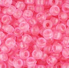 pink plastic beads are shown in close up