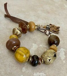 Tribal Boho Bracelet Vintage Resin and African Ethnic Lost Wax Brass Beads | eBay Bohemian Bracelets With Large Beads For Healing, Bohemian Healing Bracelets With Large Beads, Bohemian Bead Bracelet For Meditation, Bohemian Amber Beaded Bracelets Hand-strung, Gold Bracelets With Wooden Beads For Healing, Spiritual Wooden Beads, Artisan Brown Hand-strung Beaded Bracelets, Artisan Brown Beaded Bracelets Hand-strung, Adjustable Brown Beads For Crafting