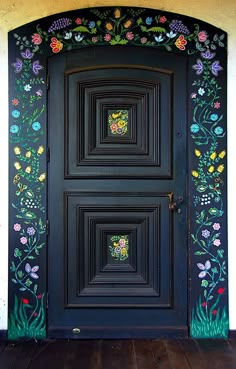 a black door with flowers painted on it