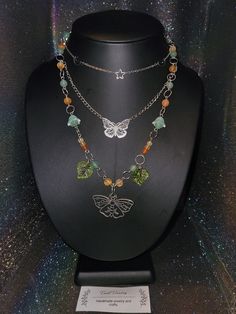 Introducing my stunning Forest Moth Necklace, a unique and remarkable piece of jewelry that will leave you in awe. This necklace is crafted with the utmost care and attention to detail, featuring a mesmerizing combination of green, orange colors with delicate leaves that symbolize nature's beauty. The centerpiece of this necklace is the exquisite moth pendant which exudes confidence and creativity. The green aventurine and protective carnelian stones surrounding it offer a sense of tranquility, Goblincore Crafts Necklaces, Whimsical Multicolor Pendant Necklace, Unique Green Jeweled Jewelry, Handmade Orange Necklace, Handmade Orange Long Necklace, Green Spiritual Necklace For Festival, Green Spiritual Necklace For Festivals, Bohemian Multicolor Clavicle Chain Necklace, Unique Orange Long Necklace