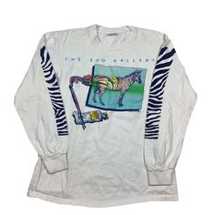 Vintage 1983 The Zoo Gallery Long Sleeve Stand Out From The Herd Zebra single, stitch T-shirt. Made in the USA. Double sided graphic. Measures as an XS/XXS. 17 inches pit to pit, 24 inches long. Excellent vintage condition. Smoke and pet free home. 80s single stitch T-shirt. USA made. 90s Graphic Print Long Sleeve T-shirt, Retro Long Sleeve T-shirt With Screen Print, 90s Long Sleeve Graphic T-shirt, Retro Long Sleeve Tops With Graphic Design, 90s Style White Tops With Vintage Print, Vintage Long-sleeve Graphic Print T-shirt, Vintage White Long Sleeve T-shirt, 90s Long Sleeve Pre-shrunk Tops, 90s Style Long Sleeve Pre-shrunk Top