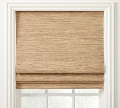 a beige roman blind in front of a window