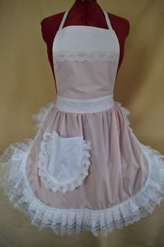 the apron is pink with white lace on it