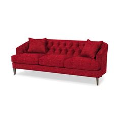 a red couch sitting on top of a white floor