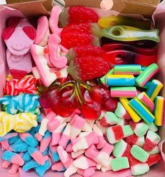 a box filled with lots of different colored candies