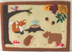 an embroidered wall hanging with animals and mushrooms