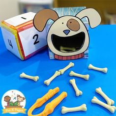 a dog themed table with bone bones and paper cutouts for the number two game