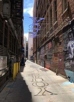 an alleyway with graffiti on the walls