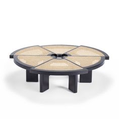 the table is made out of black wood and has four circular pieces on each side