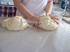 a person kneading dough on top of a counter