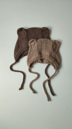 two knitted hats with ears on top of each other