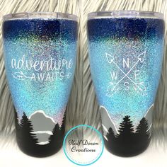 two blue and white glittered tumbles with trees on them, one has the words adventure await