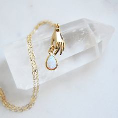 Catching a falling teardrop! This delicate opal necklace is created with a dainty 14k gold filled necklace at the length of your choice. The backside of the tiny gold plated teardrop is smooth and the tiny opal is set inside of the bezel. Your beautiful opal tear drop necklace is secured to a dainty gold hand. Whether searching for a minimalist necklace as a birthday gift for a best friend or something special just for you, all of my jewelry arrives suitably gift wrapped ready for gift giving. Measurements: The size of the opal teardrop is approx. 6mm x 11mm Metals: 18k gold plated hand 18k gold plated opal teardrop 14k gold filled jump rings 14k gold filled clasp 14k gold filled chain Minimalist opal teardrop necklace: https://www.etsy.com/listing/727988923 For more celestial gold hand ne Minimalist Teardrop Opal Jewelry, Gold Teardrop Opal Necklace, Dainty Teardrop Opal Necklace, Gold Opal Teardrop Necklace, Gift Teardrop 14k Gold Filled Drop Necklace, Opal Moon Necklace, Boho Bridal Jewelry, Hot Pink Earrings, Minimalist Necklace Gold