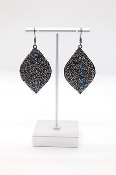 The Black Rhinestone Paved Teardrop Earrings feature a luxurious teardrop design, completely adorned with sparkling black rhinestones. Enhancing their allure, these earrings are interspersed with delicate turquoise beaded stations, adding a vibrant contrast and a touch of bohemian elegance. Black Teardrop Rhinestone Jewelry, Black Teardrop Jewelry With Rhinestones, Black Beaded Teardrop Earrings, Teardrop Metal Crystal Earrings With Rhinestones, Black Rhinestone, Turquoise Earrings, Turquoise Beads, Christmas Sale, Teardrop Earrings