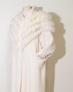 "Norma Canada Cream Alpaca and Fox Winter Coat Gorgeous Cream Statement alpaca coat with tiered fox fur & white leather detailing on chest & shoulders and leather lined collar for full coverage warmth, one of a kind , art to wear. A Norma Canada piece is always so special in every way. Incredible  Features: leather lined collar, leather coated button snaps, satin lining, two front/side pockets, white luxe satin lining, original manufacturers tag, tapered sleeve cuff with ruched detailing where sleeve meets cuff, squiggle detailing vertically on jacket, fox fur & leather tiered detail in the shape of a V across front & back of chest/shoulders area Label: Norma Canada Made in Canada Era: 1980s Marked Size: M Estimated Fit: M-L Fabric: dyed shadow fox detailing, 100% leather detailing, 70% al White Wool Coat For Winter Formal, White Wool Coat For Formal Winter Occasions, Formal Outerwear With Faux Fur Trim, Classic White Fur Coat For Winter, White Fitted Long Fur Coat, Luxury White Outerwear With Faux Fur Lining, Luxury White Fur Coat With Faux Fur Lining, White Long Coat With Faux Fur Lining, Luxury White Fur Coat For Winter