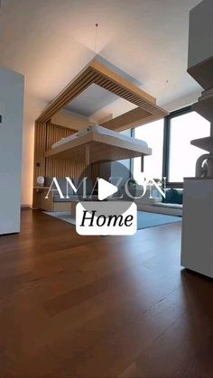 an empty living room with wood floors and white appliances in front of a large window