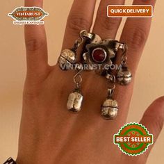 * This vintage tribal ring is such an ethereal piece we have displayed in our collection. The silver tribal ring is from the Kuchi tribe of Central Asia. The silver bells on this ring are fully justifying the fact that this is a tribal piece. The maroon stone beautified on the top of the ring is conveying an ancient feel. *There are two different styles for this delicate tribal ring to be adorned. First, massive silver dangling bells and second is small silver rhythmic bells beautified on this t Vintage Toe Ring For Jewelry Making, Vintage Metal Rings For Festival, Vintage Sterling Silver Jewelry For Festivals, Vintage Festival Ring, Festival Metal Bells Jewelry, Vintage Oxidized Finish Toe Ring Jewelry, Festival Jewelry With Bells As Gifts, Antique Silver Bohemian Ring, Bohemian Antique Silver Ring