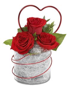 red roses in a heart shaped vase with wire wrapped around the base and leaves on top