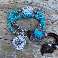 Genuine Arizona Sleeping Beauty turquoise bracelet.  Paired with beautiful artisan custom Blue Moon turquoise and 925 silver button and matching bracelet connector with feather embellishments.  Beautiful baby blue Arizona Sleeping Beauty turquoise flat nugget beads about about 11mm down to 5mm, Karen Hill Tribe fine silver beads and link, artisan sterling silver true north compass charm, 3 artisan sterling silver crimp covers, 1 sterling silver charm link and supple Deer leather lace.  Bracelets Bohemian Sterling Silver Bracelets, Bohemian Bracelets With Sterling Silver Clasp, Blue Bohemian Bracelets With Charms, North Compass, True North, Sleeping Beauty Turquoise, Silver Buttons, Matching Bracelets, Blue Moon