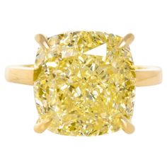 This solitaire ring is a masterpiece of craftsmanship, created by the renowned Antinori Di Sanpietro. It features a magnificent 4-carat cushion cut diamond, boasting a Fancy Intense Yellow color and a clarity grade of VS. This exceptional gemstone is certified by the Gemological Institute of America (GIA), ensuring its quality and authenticity. The diamond is expertly set in a luxurious band made of 18 carats yellow gold, which complements its radiant yellow hue. The ring's design is both timele Fancy Yellow Diamond Ring, Cushion Diamond Ring, Brilliant Cut Diamond Ring, Yellow Cushion, Cushion Cut Diamond Ring, Sapphire Solitaire Ring, Emerald Cut Diamond Ring, Yellow Cushions, Platinum Diamond Engagement Rings