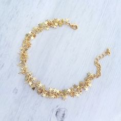 Tiny clusters of matte gold finish miniature star fringe, finished with an adjustable chain and lobster claw clasp. 14k gold plated brass. { M e a s u r e m e n t s } Bracelet shown adjusts to fit approx 6.25 - 8 in (15 - 19.5cm). Each little star is approx 1/4 inch {approx 5mm} tall. Please double check measurements on your own wrist prior to any purchase, if you have any doubt or concern about the fit. I'm happy to shorten the length free of charge if you leave me a note at checkout with your Dainty Adjustable Chain Bracelet With Star Charm, Adjustable Gold Chain Bracelet With Star Charm, Adjustable Gold Star-shaped Chain Bracelet, Adjustable Gold Star Chain Bracelet, Gold Star Charm Chain Bracelet, Gold Bracelet Jewelry With Star Charm, Gold Bracelet With Star Charm, Gold Chain Bracelet With Star Charm, Adjustable Gold Star Bracelet