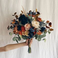 a person holding a bouquet of flowers in their hand