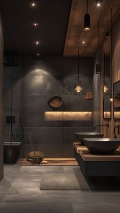 a modern bathroom with two sinks and lights on the wall above it, along with a large mirror