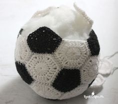 a black and white crocheted ball sitting on top of a table