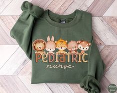 Cute Pediatric Nurse Sweatshirt, Pediatric Nurse Shirt, Pediatric Nurse Gift, Nurse Appreciation Gift, Cozy Peds Nurse Sweater ✧ SIZING ✧ ⋒ Please check our size chart before placing an order. ⋒ If you want an oversized look, pick a sweatshirt that is 2 sizes larger than your usual size. ✧ IMPORTANT NOTE: We try to depict all shirt and design colors as close to the original as possible but depending on your screen settings or the shirt color you chose, the colors of the graphics may vary slightl Cute Green Sweatshirt With Letter Print, Bliss Products, Peds Nurse, Nurse Sweater, Nursing Shirt, Nursing Hoodie, Pediatric Nurse, Nursing Accessories, Nurse Appreciation Gifts