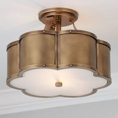 a light fixture in a room with white walls and ceiling lights on the ceiling,