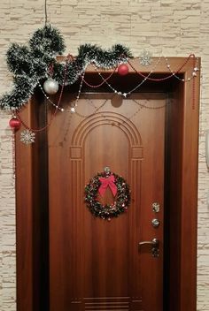 a wooden door decorated with christmas decorations