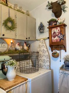 the kitchen is decorated with country decor and farm animals on the wall above the dishwasher