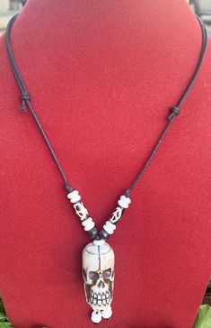 Skull pendant Necklace with adjustable black cord. Handmade in Nepal from Yak bone. The adjustable necklace can be extended to 28 inches or shortened to 14 inches. Skull Pendant Necklace, Skull Pendant, Adjustable Necklace, Nepal, Bones, Pendant Necklace, Pendant, Black