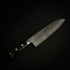 a large knife on a black background